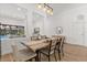 Elegant dining room features modern lighting and is open to the spacious living area with a view of the pool at 356 Via Tuscany Loop, Lake Mary, FL 32746