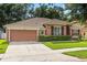 Charming single-story home with a well-manicured lawn, two-car garage and mature trees in a suburban setting at 356 Via Tuscany Loop, Lake Mary, FL 32746