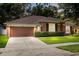 Attractive home with a paved driveway, well-kept lawn, and an attached garage at 356 Via Tuscany Loop, Lake Mary, FL 32746