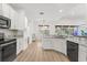 Modern kitchen with white cabinets, granite countertops, stainless appliances and hardwood floors at 356 Via Tuscany Loop, Lake Mary, FL 32746