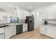 Bright kitchen features white cabinets, stainless appliances, granite countertops, and a stylish backsplash at 356 Via Tuscany Loop, Lake Mary, FL 32746