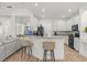 Modern kitchen featuring white cabinets, granite countertops and a breakfast bar, open to the living area at 356 Via Tuscany Loop, Lake Mary, FL 32746