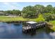 This stunning aerial view showcases a serene lake with a charming dock, perfect for lakeside relaxation and water activities at 356 Via Tuscany Loop, Lake Mary, FL 32746