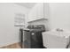 Bright laundry room featuring modern washer and dryer, utility sink, and ample cabinet space at 356 Via Tuscany Loop, Lake Mary, FL 32746