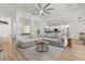 Open-concept living area with stylish furnishings, hardwood floors and seamless flow to the kitchen at 356 Via Tuscany Loop, Lake Mary, FL 32746