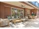 A covered patio boasts comfortable seating and a ceiling fan, offering the perfect space for outdoor relaxation and entertaining at 356 Via Tuscany Loop, Lake Mary, FL 32746