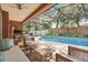 Inviting outdoor patio featuring a sparkling pool, comfortable seating, and a beautiful screened enclosure at 356 Via Tuscany Loop, Lake Mary, FL 32746