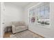 Small, bright sitting room featuring a loveseat with a window providing natural light and a light colored wooden floor at 356 Via Tuscany Loop, Lake Mary, FL 32746