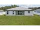 View of backyard featuring a well-maintained lawn and patio area at 3944 Sw 130Th Loop, Ocala, FL 34473