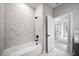 Bathroom with tub and marble tiled walls at 3944 Sw 130Th Loop, Ocala, FL 34473