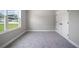 Neutral bedroom with carpet, large window and closet at 3944 Sw 130Th Loop, Ocala, FL 34473