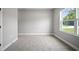 Carpeted bedroom with neutral walls and a large window at 3944 Sw 130Th Loop, Ocala, FL 34473