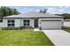Charming single-story home with well-manicured lawn and attached two car garage on a sunny day at 3944 Sw 130Th Loop, Ocala, FL 34473