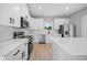 Bright kitchen with stainless steel appliances, quartz countertops and sleek, all-white cabinetry at 3944 Sw 130Th Loop, Ocala, FL 34473