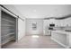 Bright kitchen with stainless steel appliances, quartz countertops, center island, sleek white cabinetry and large pantry at 3944 Sw 130Th Loop, Ocala, FL 34473