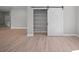 Large pantry with sliding barn door for storage and sleek, light wood-style flooring throughout at 3944 Sw 130Th Loop, Ocala, FL 34473