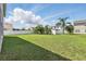 Expansive grassy back yard enclosed by a white fence, providing privacy and ample space for recreation at 4208 Lugano Ct, Kissimmee, FL 34746