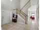 Inviting foyer with tile flooring, high ceilings, staircase, and a view of the living area at 4208 Lugano Ct, Kissimmee, FL 34746