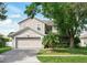 Charming two-story home featuring a well-maintained lawn, mature trees, and a two-car garage at 4208 Lugano Ct, Kissimmee, FL 34746
