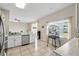 Bright kitchen with stainless steel appliances, white cabinets, and backyard view at 4208 Lugano Ct, Kissimmee, FL 34746