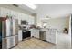 Well-lit kitchen featuring stainless steel appliances, white cabinetry, and tile floors at 4208 Lugano Ct, Kissimmee, FL 34746