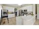 Modern kitchen with white cabinetry, stainless steel appliances, and a breakfast bar for casual dining at 4208 Lugano Ct, Kissimmee, FL 34746