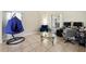 Living room with unique hammock chair, glass coffee table, and dual workstation at 4208 Lugano Ct, Kissimmee, FL 34746