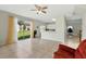Bright living room features tile flooring, access to the backyard, and an open view to the kitchen at 4208 Lugano Ct, Kissimmee, FL 34746