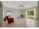 Bright living room with tile flooring, natural light, and access to the backyard through sliding doors at 4208 Lugano Ct, Kissimmee, FL 34746