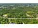 A sprawling aerial view showcases the density of trees, a small home, and a road at 4825 N Fort Christmas Rd, Christmas, FL 32709