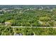 Picturesque aerial view captures a home and land with a road nearby, surrounded by lush green trees at 4825 N Fort Christmas Rd, Christmas, FL 32709