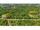 An aerial view displays property lines encompassing a home and a densely wooded parcel of land at 4825 N Fort Christmas Rd, Christmas, FL 32709