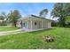Exterior view of charming home with a blue front door and well-maintained lawn at 5115 W Livingston St, Orlando, FL 32811