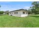 An exterior shot of the home showing the side of the house and backyard at 5115 W Livingston St, Orlando, FL 32811