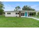 Charming single-story home with a well-manicured lawn and a bright blue front door at 5115 W Livingston St, Orlando, FL 32811