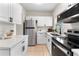 Bright kitchen featuring stainless steel appliances, and quartz countertops at 5115 W Livingston St, Orlando, FL 32811