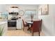 Kitchen area with stainless appliances and a round table dining set with three chairs at 5115 W Livingston St, Orlando, FL 32811