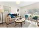 Bright living room featuring neutral tones, stylish furniture, and ample natural light at 5115 W Livingston St, Orlando, FL 32811