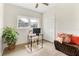 Functional home office features a bright window, desk setup, closet, and cozy seating area at 5115 W Livingston St, Orlando, FL 32811