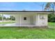 A covered patio and back door on the rear exterior of the home at 5115 W Livingston St, Orlando, FL 32811