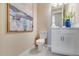 Half bathroom with a picture and a decorative flower arrangement on the counter at 5684 Gingham Dr, Kissimmee, FL 34758
