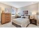 Serene bedroom with neutral tones, decorative UCF sign, and classic wooden furniture at 5684 Gingham Dr, Kissimmee, FL 34758