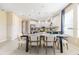 Dining area with modern table and chairs adjacent to bright kitchen at 5684 Gingham Dr, Kissimmee, FL 34758