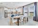 Open dining area features modern light fixtures, table, and seating with windows letting in natural light at 5684 Gingham Dr, Kissimmee, FL 34758