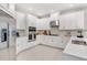 Beautiful white kitchen with stainless steel appliances, quartz countertops, and modern cabinetry at 5684 Gingham Dr, Kissimmee, FL 34758