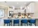 Stylish kitchen with white cabinets, stainless steel appliances, and seating at the breakfast bar at 5684 Gingham Dr, Kissimmee, FL 34758