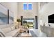 Bright and airy living room with soaring ceilings, large windows, and elegant furniture at 5684 Gingham Dr, Kissimmee, FL 34758