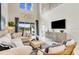 Bright and airy living room with soaring ceilings, large windows, and elegant furniture at 5684 Gingham Dr, Kissimmee, FL 34758