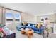 Comfortable upstairs living room with a cozy blue sectional sofa and lots of natural light at 5684 Gingham Dr, Kissimmee, FL 34758