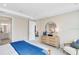 Main bedroom with a dresser and sitting chair next to an ensuite bathroom at 5684 Gingham Dr, Kissimmee, FL 34758